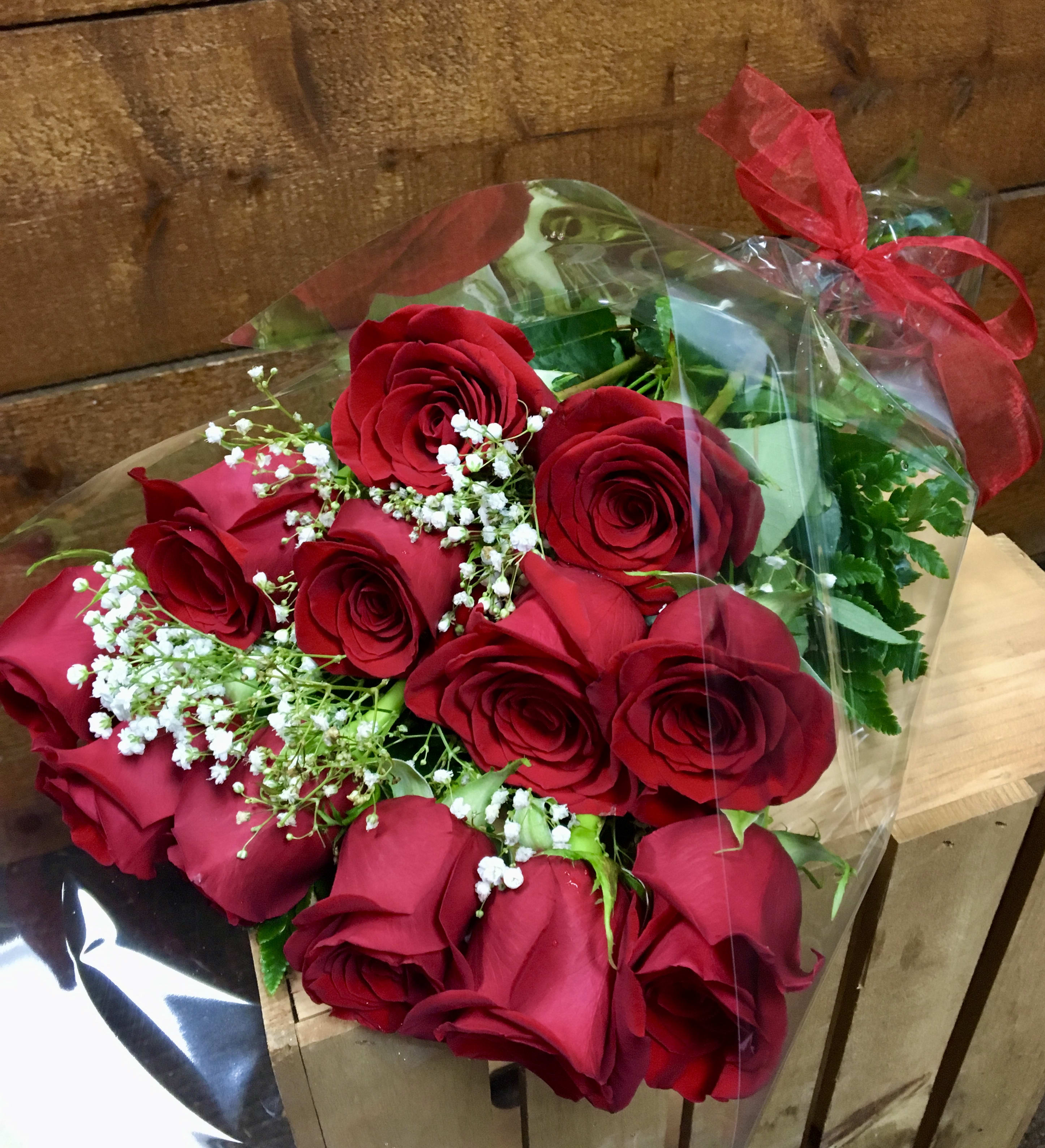Bouquet of red roses with baby's breath in clear wrap