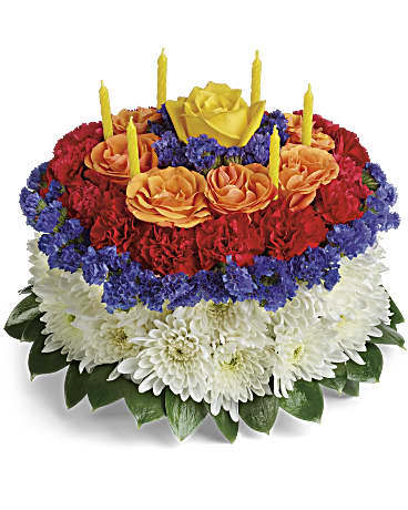 Your Wish Is Granted Birthday Cake Bouquet - A slice of birthday fun! Creative and colorful, this birthday cake bouquet of roses, carnations and mums is a fun-filled surprise on their special day. Birthday candles top it off in festive style!  This cute cake arrangement is made up of yellow roses, orange spray roses, red miniature carnations, white cushion spray chrysanthemums, blue sinuata statice, and israeli ruscus. Delivered on a designer tray.