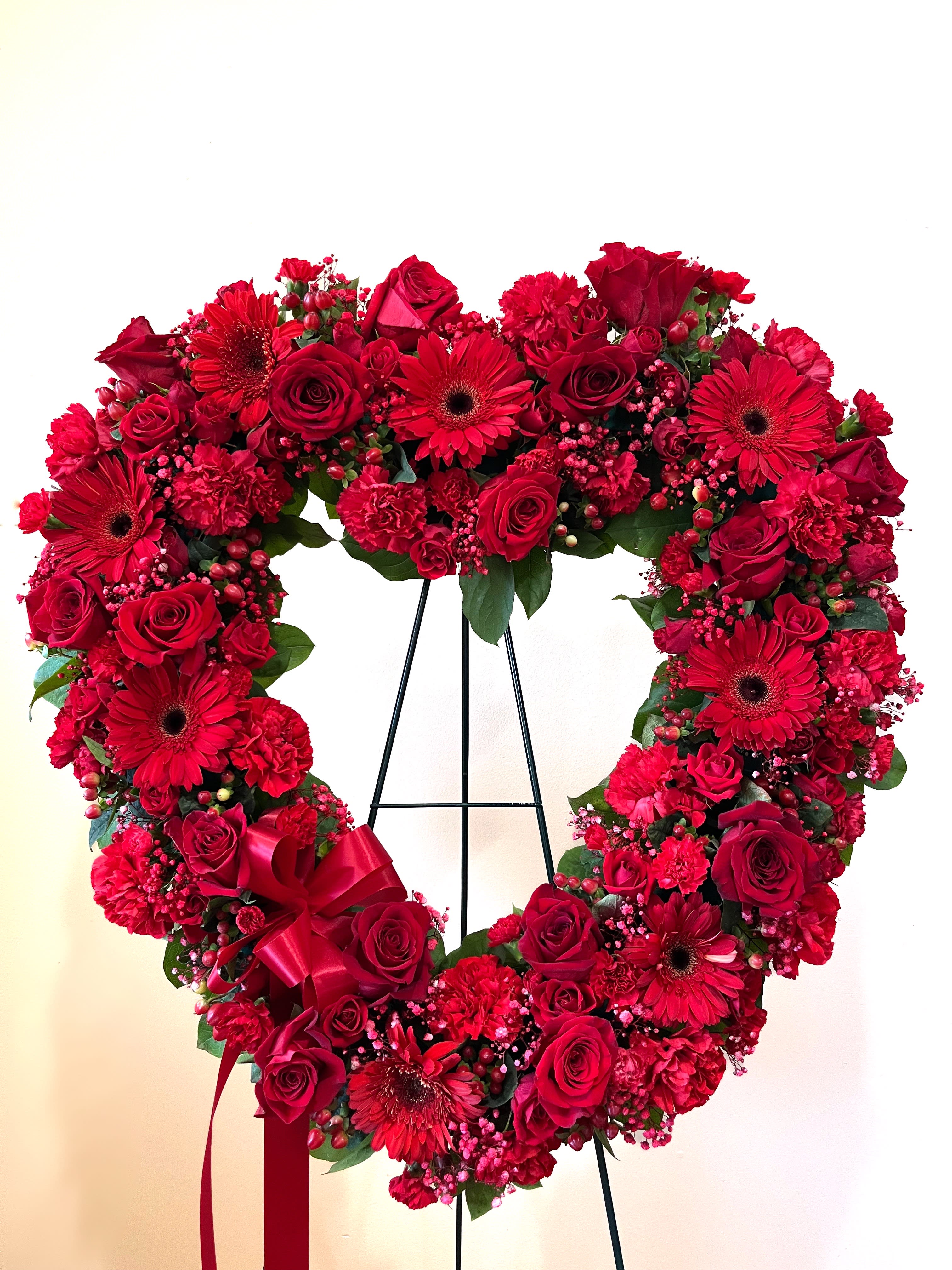 Always Remember Floral Heart Tribute- Red - The love for someone who has passed away lives on forever in the hearts of those left behind. This sentiment is best captured with our standing, open heart-shaped red floral arrangement. Handcrafted by our caring florists with an assortment of radiant red blooms, it is a magnificent tribute fitting for the funeral services.