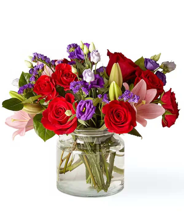Truly Stunning Bouquet - This dreamy jewel toned bouquet combines bold colour and eye catching texture to make a loving statement. Featuring a bold array of red roses, pink lilies, purple double lisianthus and purple sinuata statice, this dazzling assortment is bound to impress your recipient.