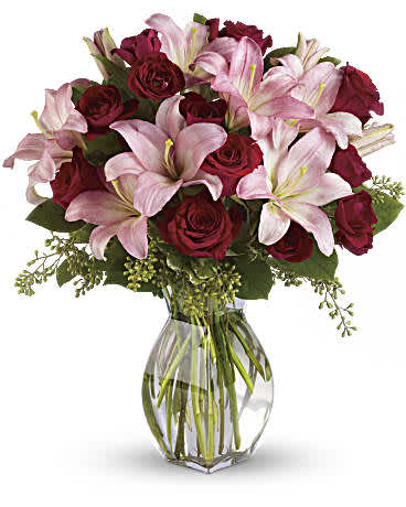 Lavish Love Bouquet - Lavish your loved one with luxuriant reds and pinks. A romantic anniversary gift or sumptuous surprise, it stars fragrant pink asiatic lilies and rich red roses for a feminine twist on the classic rose bouquet. Pink asiatic lilies, red roses and greens including seeded eucalyptus and variegated pittosporum. Orientation: All-Around ** VASE WILL VARY**