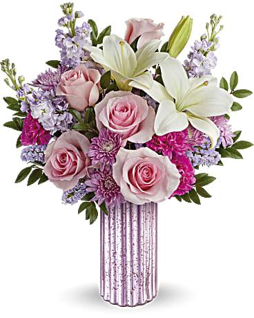 Pink roses and white lilies in a striped vase