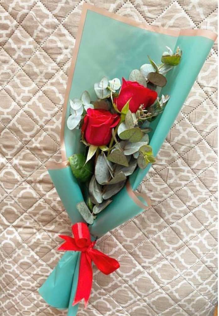 Roses Pinterest Style - 2 Red Roses with Eucalyptus in a wrapped small bouquet. Paper color may vary depending on availability.