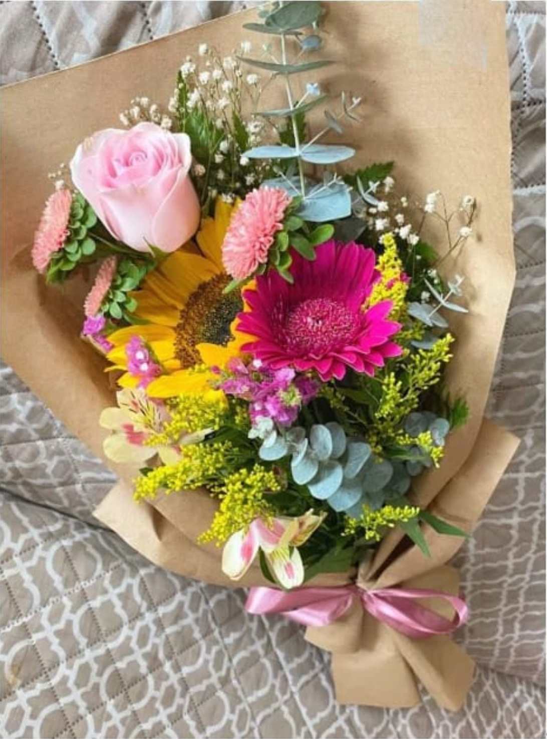 Small and Beautiful Wrapped Bouquet - Gerbera, Sunflower, Alstroemeria, Mini Carnations, Rose, Eucalyptus, Solidago and Baby Breath in a Small Wrapped Bouquet. Flowers colors may vary depending on availability. 