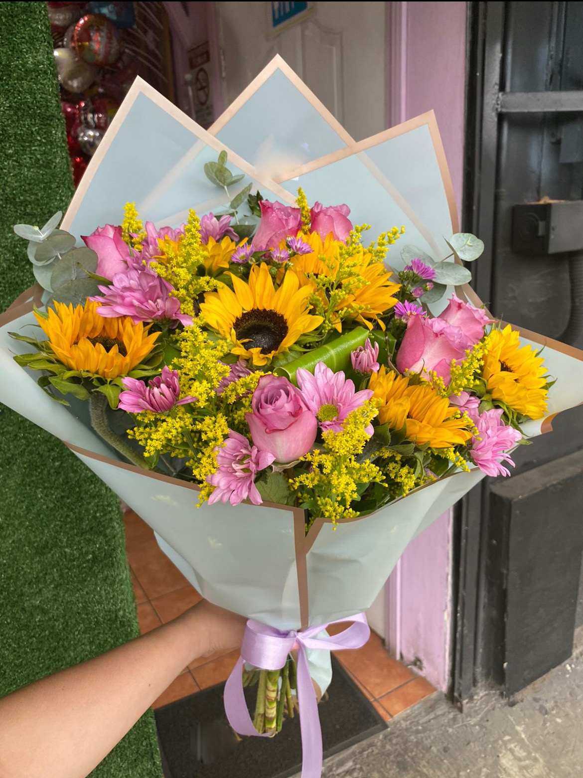 Lavander Roses and Sunflowers - Lavander Roses, Sunflowers, and Lavander Daisies with Solidago and Eucalyptus accents.  Paper color may vary depending on availability