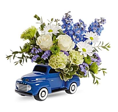 Enjoy the Ford Bouquet - Bursting with a whimsical blue, white and green bouquet, this fun-filled ceramic Ford delivers smiles across the miles! This arrangement features white roses, green carnations, blue delphinium, white daisy spray chrysanthemums, green cushion spray chrysanthemums, blue sinuata statice, variegated pittosporum and parvifolia eucalyptus. Delivered in Teleflora's '48 Ford Pickup Keepsake. Orientation: All-Around