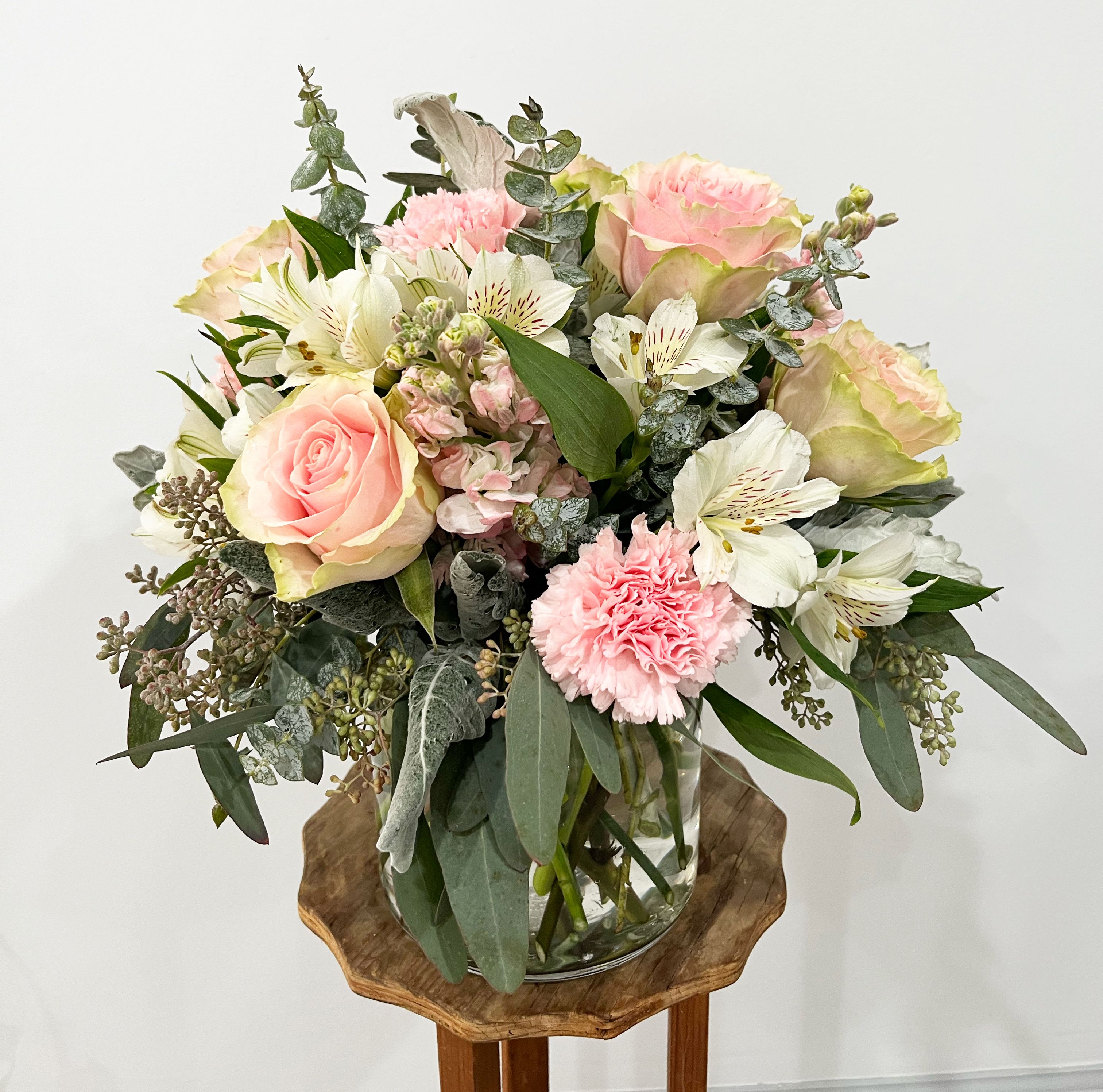 Blush Bouquet - You’ll have them at first blush when they see this stunning bouquet. We’ve gathered a lush mix of blooms in soft shades of pink, peach and white for everyday elegance. Artistically designed in a stylish clear glass cylinder vase, it’s a heartfelt gift for birthdays, anniversaries or just to tickle someone pink. 