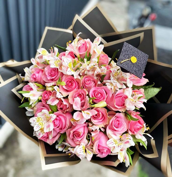 Graduation Pink Roses - 25 Pink Roses with Alstroemeria wrapped in black paper and with a Grad Hat touch. 