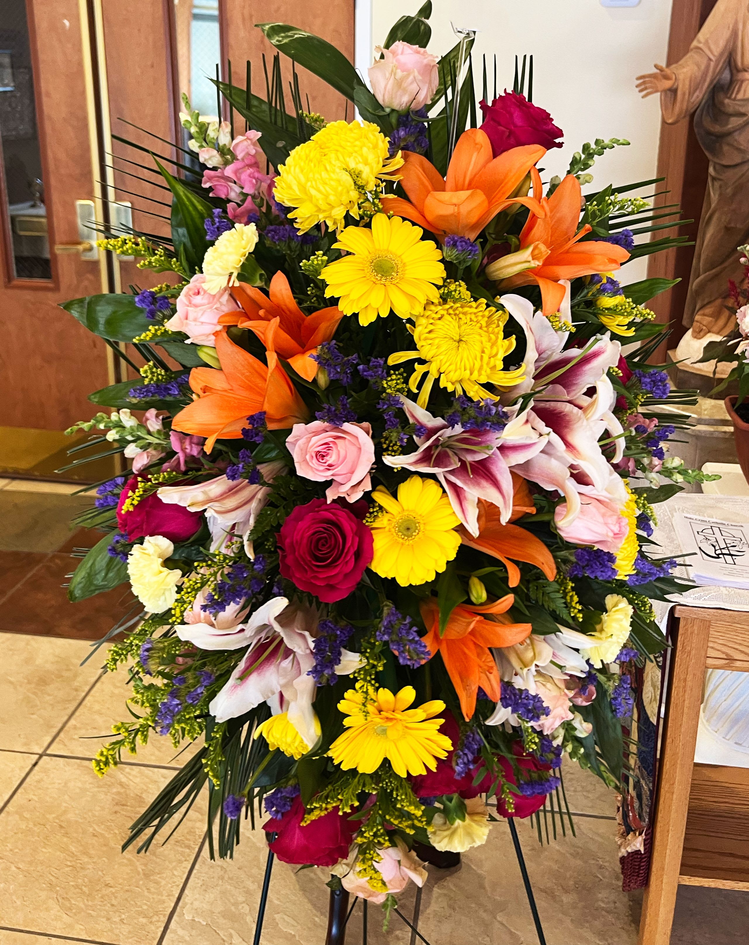 Sympathy Standing Spray - Bright - Their passion and joy for life will always be remembered. Our classic standing spray arrangement was designed to capture that colorful spirit. Elegantly crafted for a lush, full presentation, this vibrant mix of blooms creates a memorable tribute to someone who was truly one-of-a-kind.