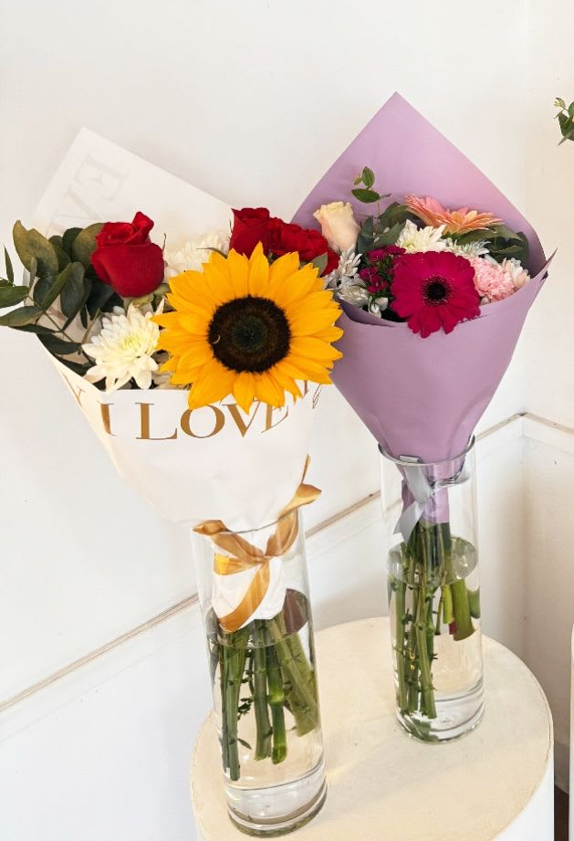 Floral Cone - Floral Cone with a mix 3 Focal Flowers with Daisies, mini carnations and Eucalyptus.** FLOWERS WILL DEPEND OF STORE AVAILABILITY** ** VASE NOT INCLUDED** ** PAPER COLOR WILL DEPENDE STORE AVAILABILITY** ** YOU CAN SUGGEST SPECIFIC FLOWERS AND COLORS, WE WILL DO OUR BEST !!! ***