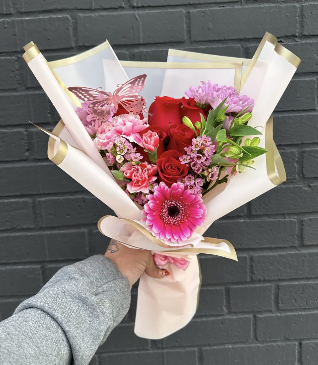 Rosé Radiance Bouquet - FLORIST CHOICE COLORS. 6 roses, assorted fillers, and greenery. Includes butterfly ** FLOWERS WILL DEPEND ON STORE AVAILABILITY**  ** PAPER COLOR WILL DEPEND ON STORE AVAILABILITY** 