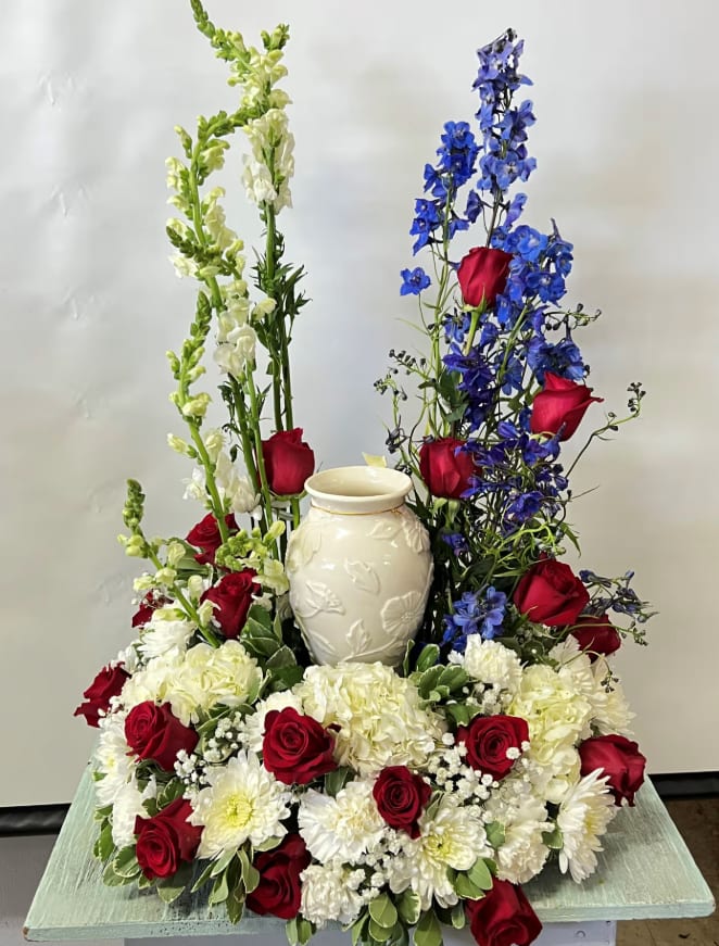 Sympathy Urn Arrangement  - Cremation arrangement. Vase not included only used as an example as to where urn will be placed. Arrangement designed in white, red and blue colors. Colors can be modified depending on availability.