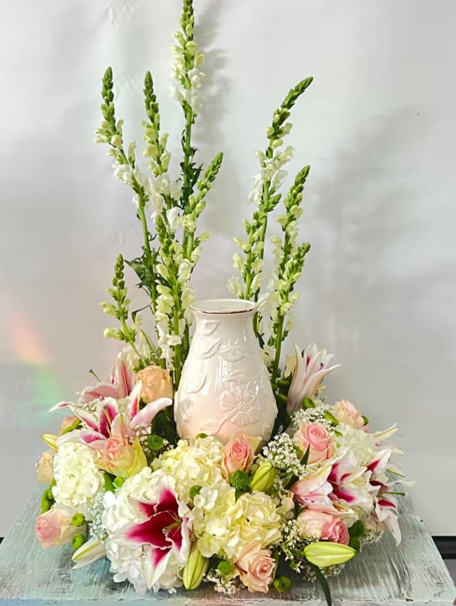 Deepest Sympathy Urn Arrangement - Cremation arrangement. Vase not included only used as an example as to where urn will be placed. Arrangement designed in white and pink colors. Colors can be modified depending on availability.