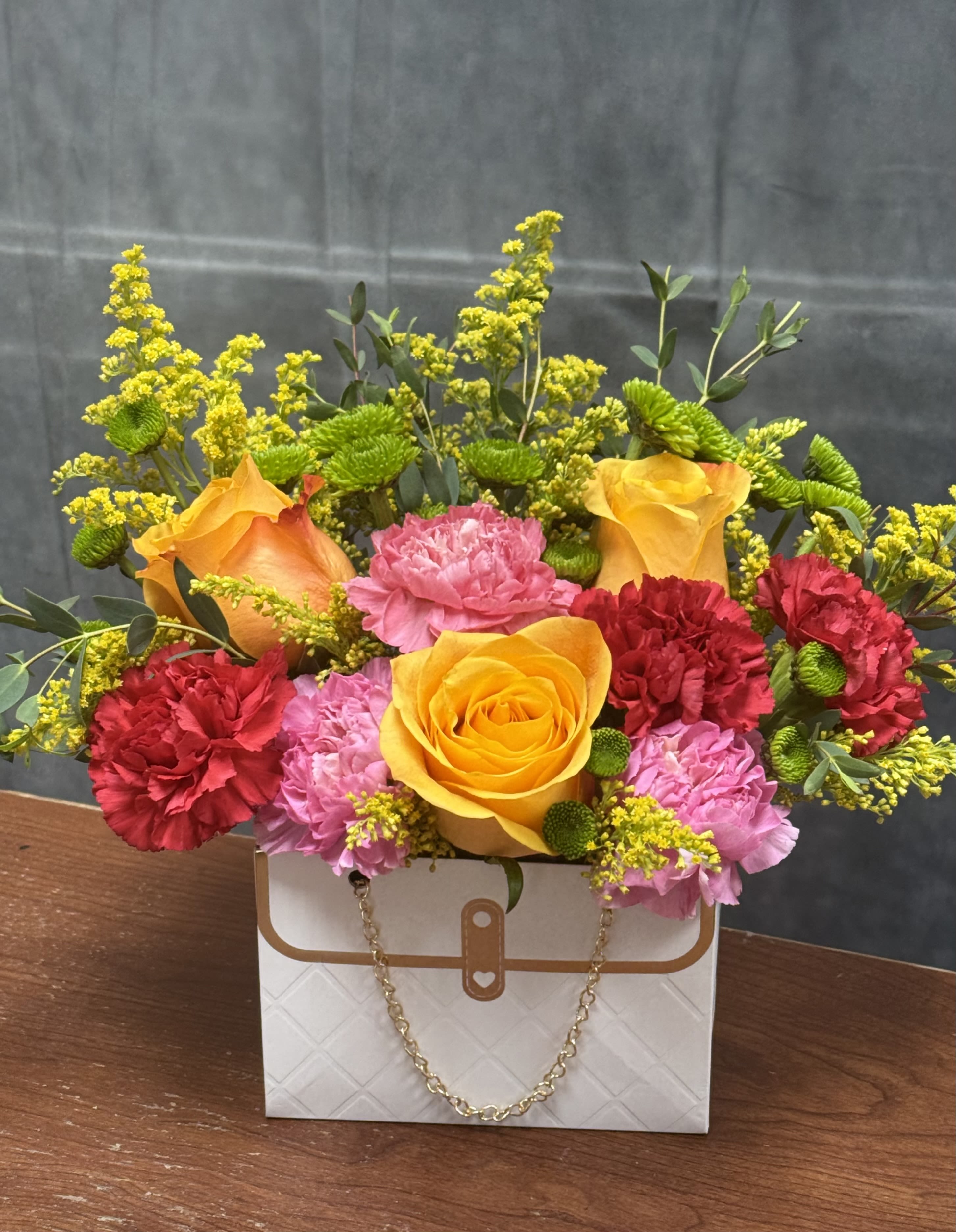 CHEERFUL - Step into a world of vibrant delight with our cheerful flower arrangement, a lively tapestry of orange, red, and purple blooms. Immerse yourself in the radiant energy and bold hues that define this captivating ensemble. 