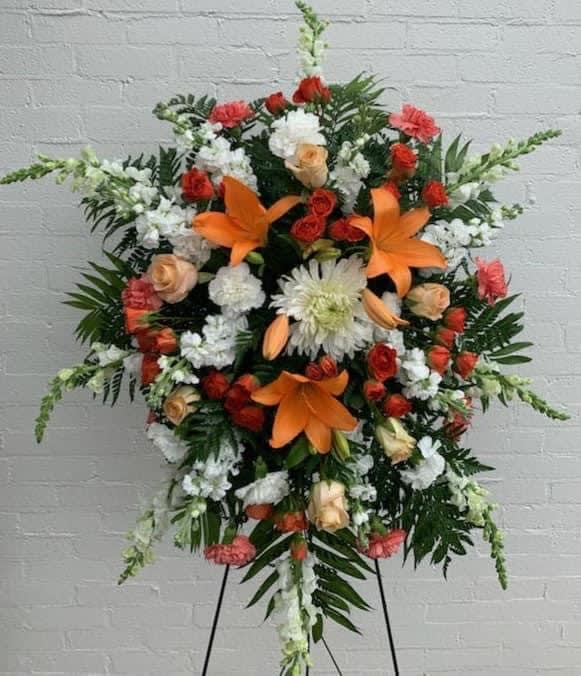 Standing floral spray with orange lilies, red and white flowers