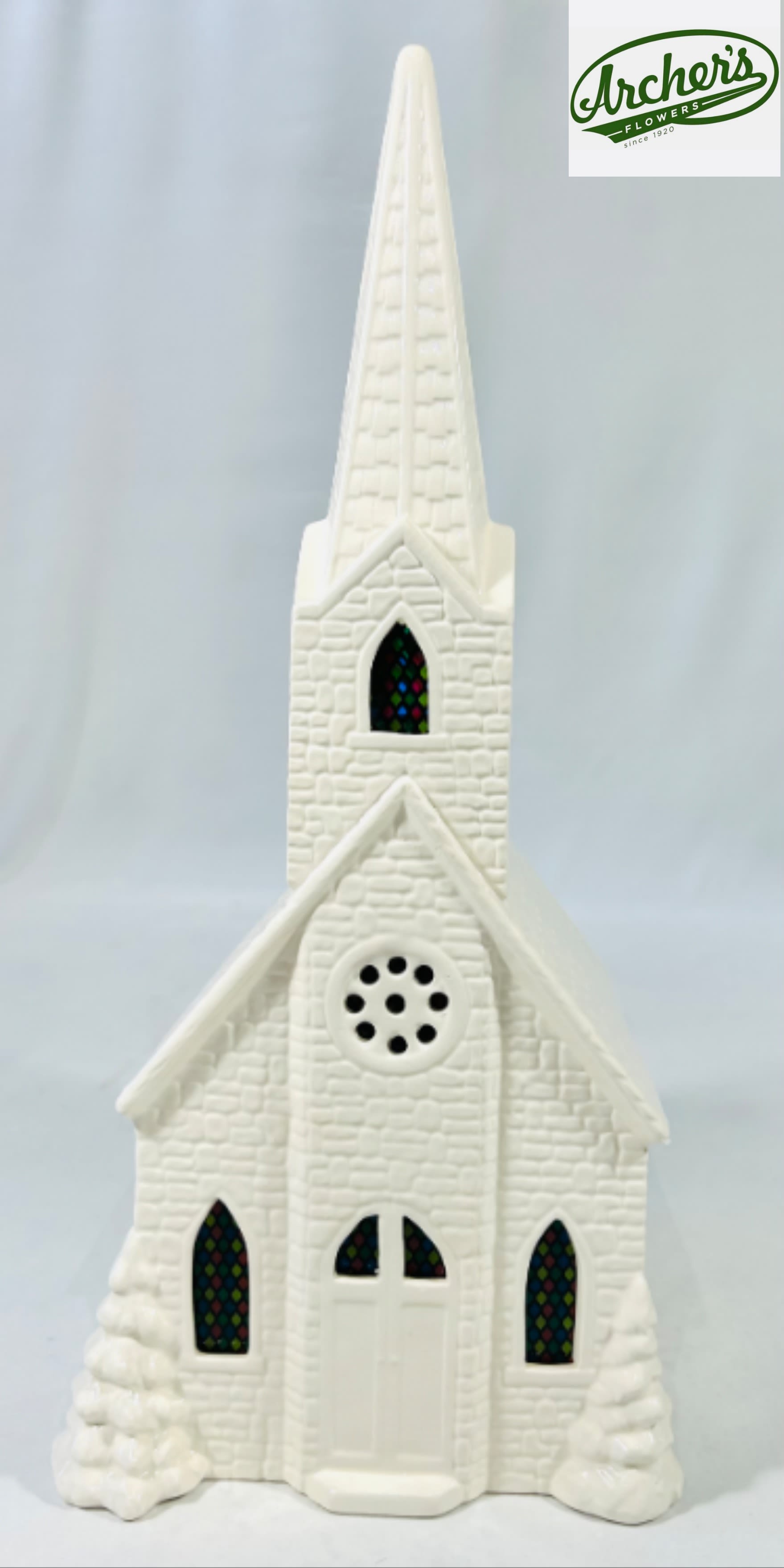 White church figurine with a tall steeple and stained-glass windows