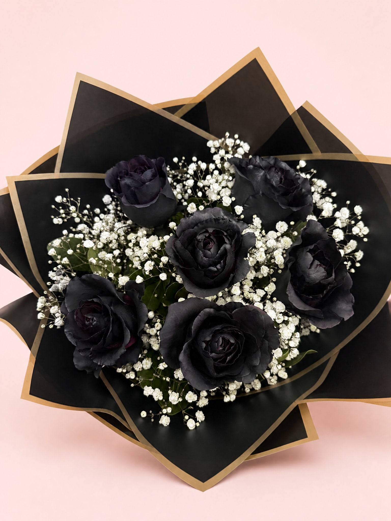 Bouquet of black roses with white baby's breath in black and gold wrap