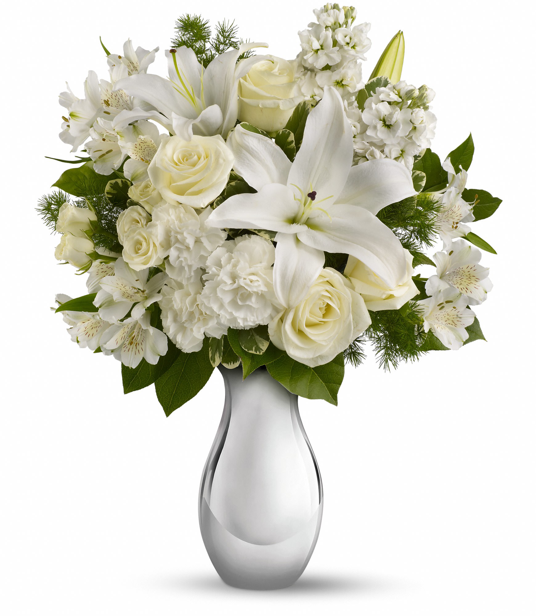 White lilies and roses arranged in a clear glass vase