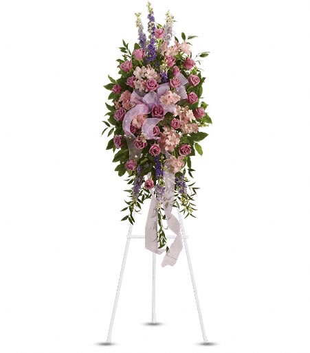 Tall pink and purple floral spray on a white easel