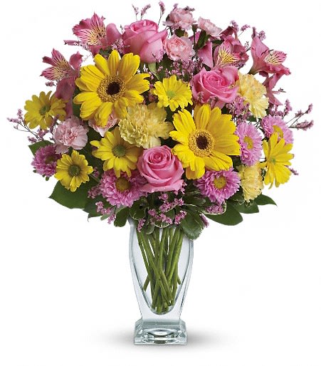 Pink and yellow mixed flower bouquet in a clear glass vase