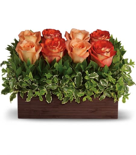 Arrangement of peach and orange roses in a rectangular wooden box