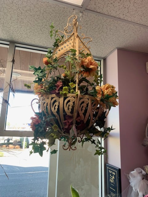 Hanging floral basket with orange blooms and ivy