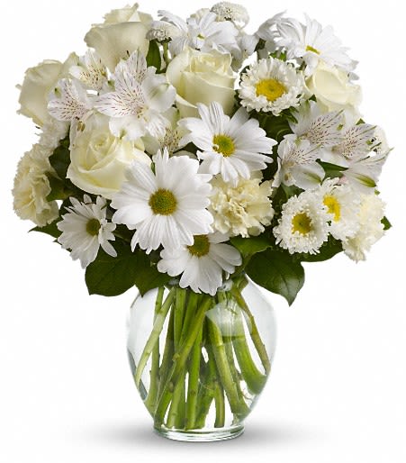 White bouquet of roses and daisies in a clear glass vase