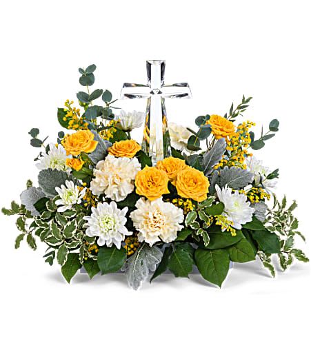 Yellow and white flower arrangement with a clear cross centerpiece