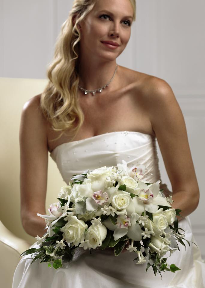 FTD White on White Bouquet - The FTDÂ® White on Whiteâ¢ Bouquet is a collection of nature's finest  white blooms to help you say your âI Do'sâ in style. White roses,  Cymbidium Orchids, hydrangea, and stephanotis are accented with a  variety of lush greens and tied together at the stems with a ivory woven  edge grosgrain ribbon to create a bouquet full of interest and  appealing texture, giving you that classic bridal look. Approx. 12âH x  13âW. 