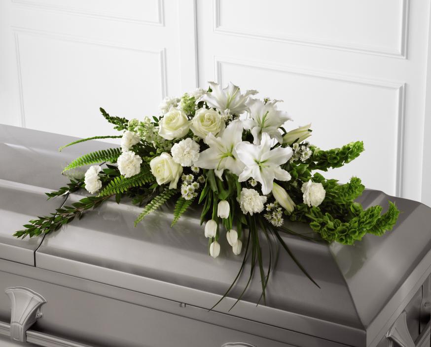 FTD Resurrection Casket Spray - The FTD Resurrection Casket Spray inspires thoughts of comfort  and peace to those wishing to pay their respects for the loss of the  deceased. White tulips, roses, snapdragons, Oriental lilies, larkspur,  carnations and monte casino asters are accented by the bright green  stems of Bells of Ireland and an assortment of the finest lush greens to  create the perfect arrangement to display on the top of their casket  during their final farewell service.    40"l x 24"w 