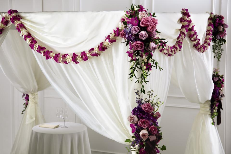 FTD Color &amp; Light Chuppah Decor - The FTDÂ® Color &amp; Lightâ¢ Chuppah DÃ©cor is a gorgeous way to make your  wedding come to life with color and floral beauty. Garlands are draped  on all four sides of the chuppah consisting of lavender roses, light  lavender roses, purple dendrobium orchids, purple hydrangea and lush  greens. Accented at each corner with additional arrangements consisting  of lavender roses, purple dendrobium orchids, lavender larkspur, light  lavender roses, purple hydrangea, ivy and additional greens, this  display will make your wedding a sight to behold. Fits an 8' x 8'  chuppah.