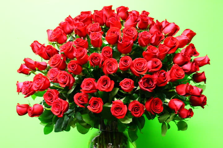 Large bouquet of red roses in a glass vase