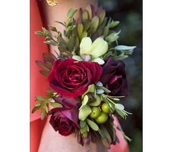 Small bouquet with deep red roses and pale green flowers