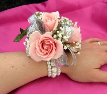 Pink rose wrist corsage with silver ribbon and pearl bracelet