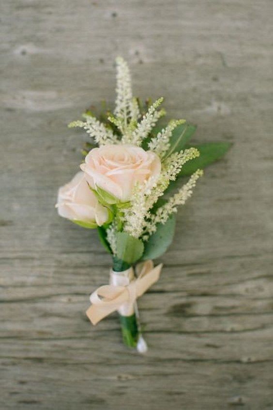 Small boutonniere with pale pink roses and white filler flowers