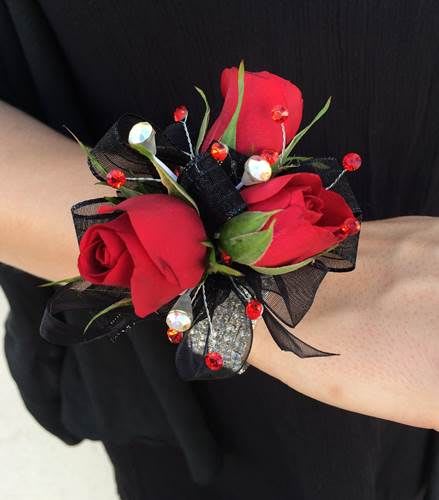 Red rose wrist corsage with black ribbon and bead accents