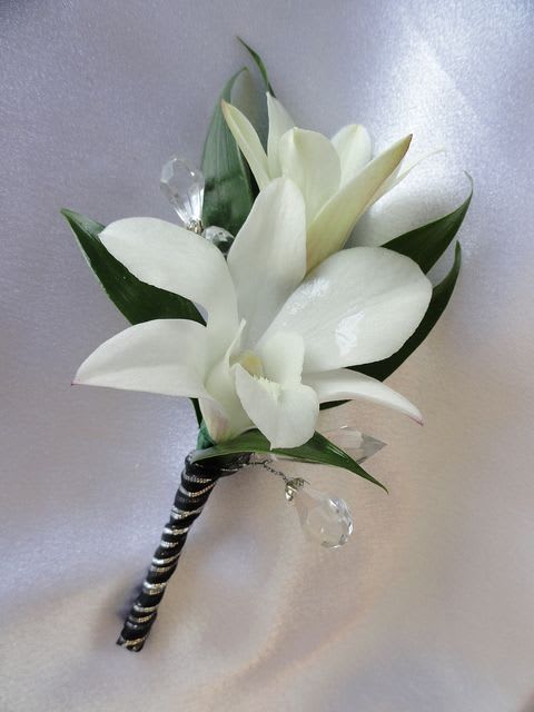 White calla lily boutonniere with black-and-silver wrapped stem