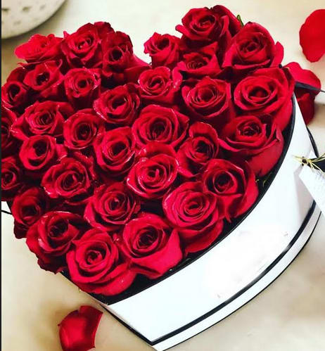 Heart-shaped box filled with red roses