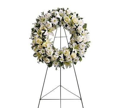 White floral wreath on a metal stand