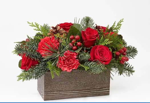 Rustic Winter - A rustic wood box filled with greens and blooms of the season.