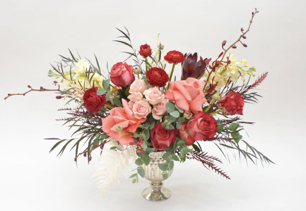 Mixed bouquet of red and pink roses in a silver vase