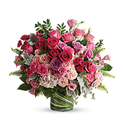 Pink and purple rose bouquet in a glass vase