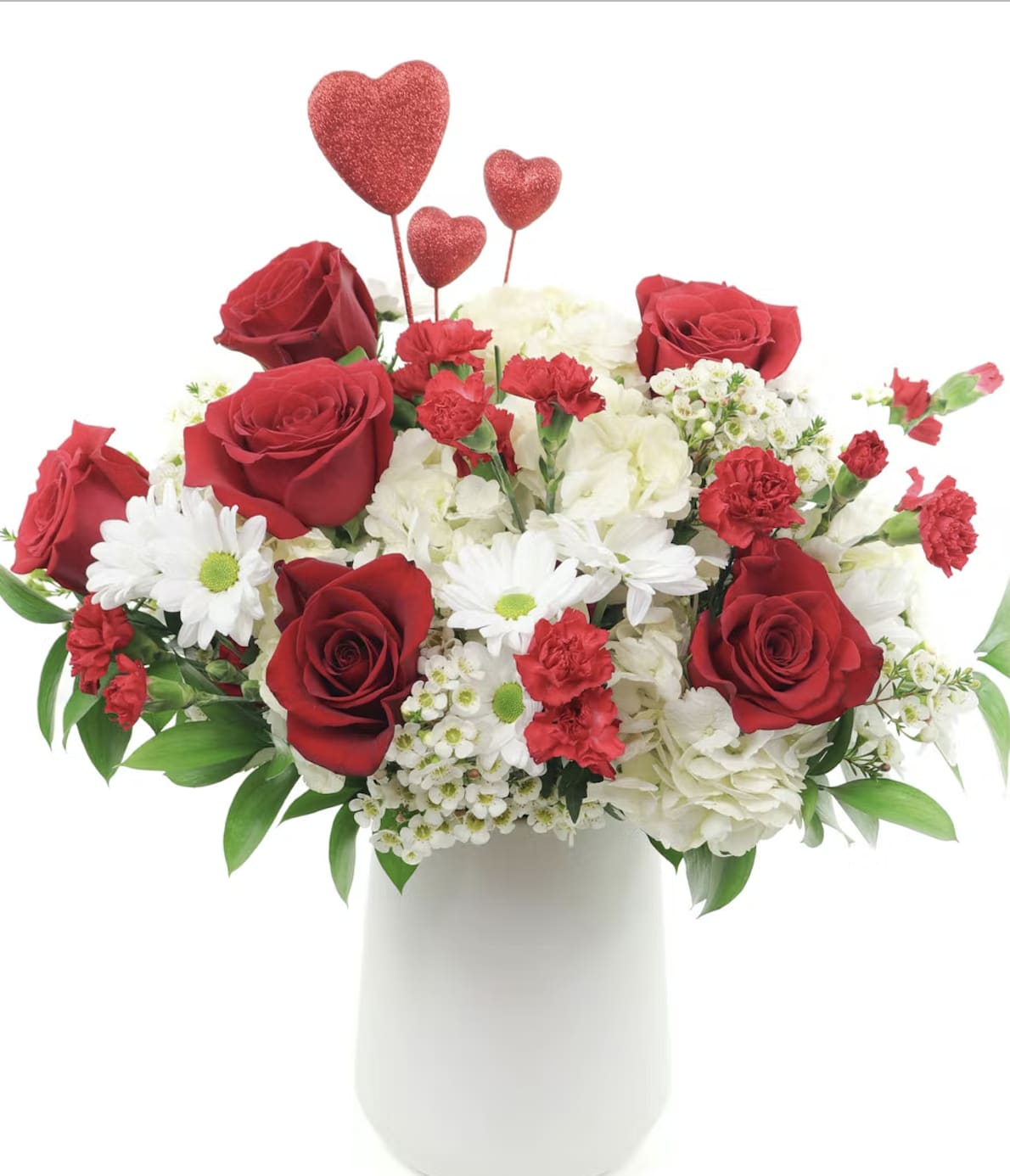 Red roses and white flowers in a white vase with heart picks