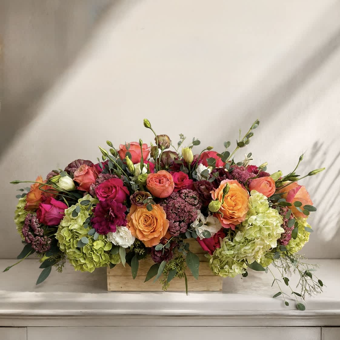 Mixed bouquet of roses and hydrangeas in a wooden box
