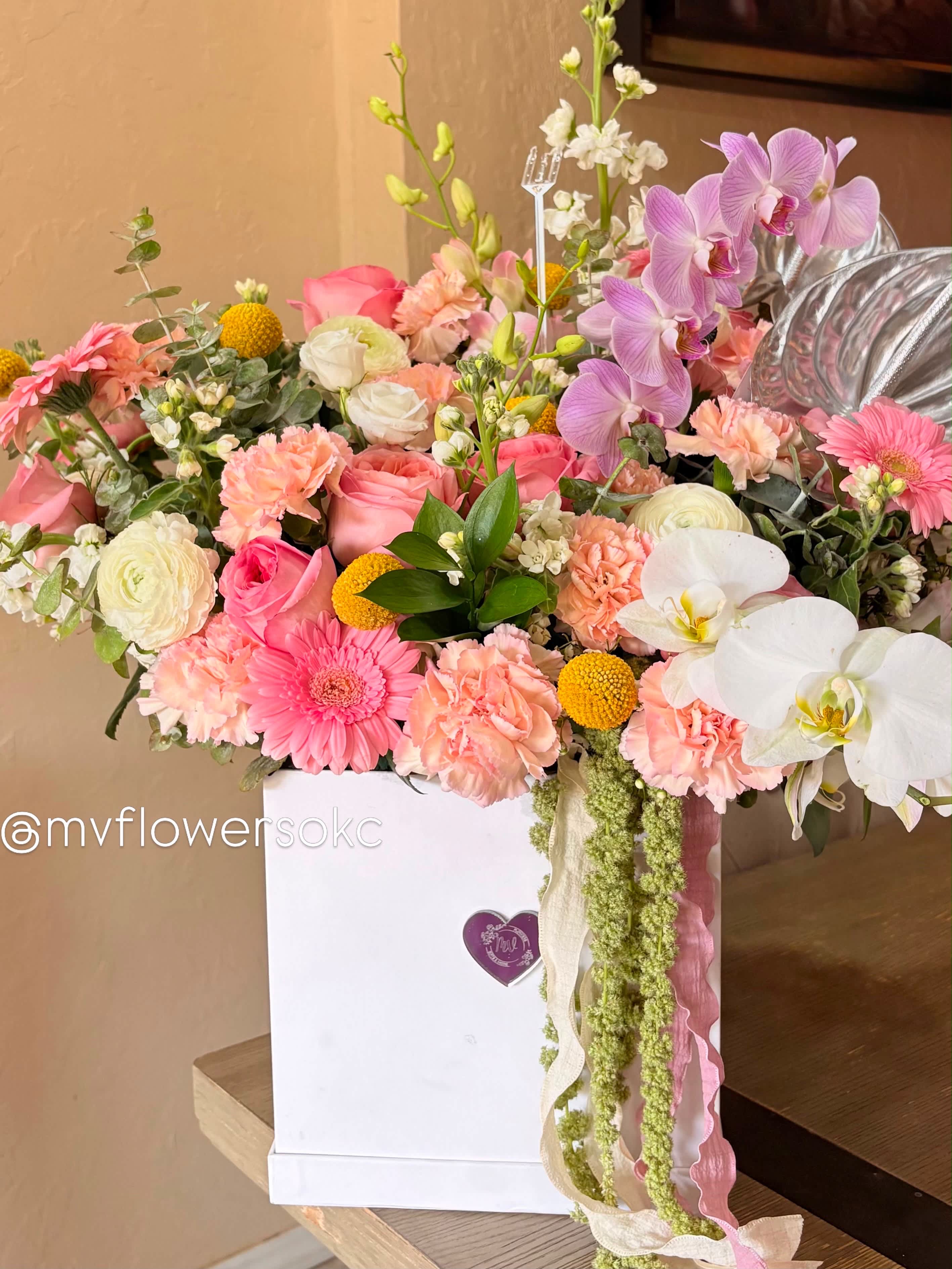 Mixed pink and white flower arrangement in a white gift box