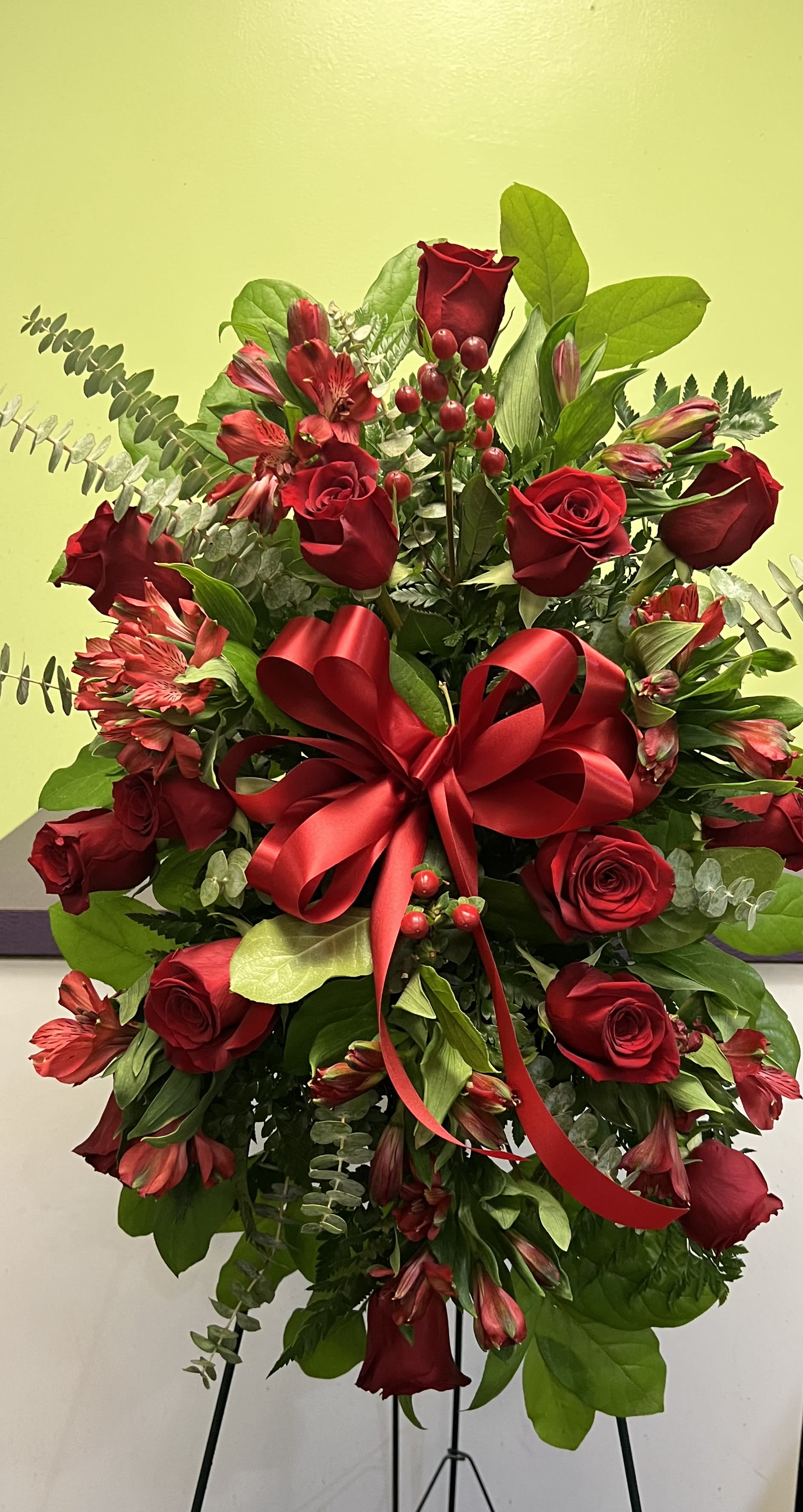 Red rose and alstroemeria arrangement with a large red ribbon