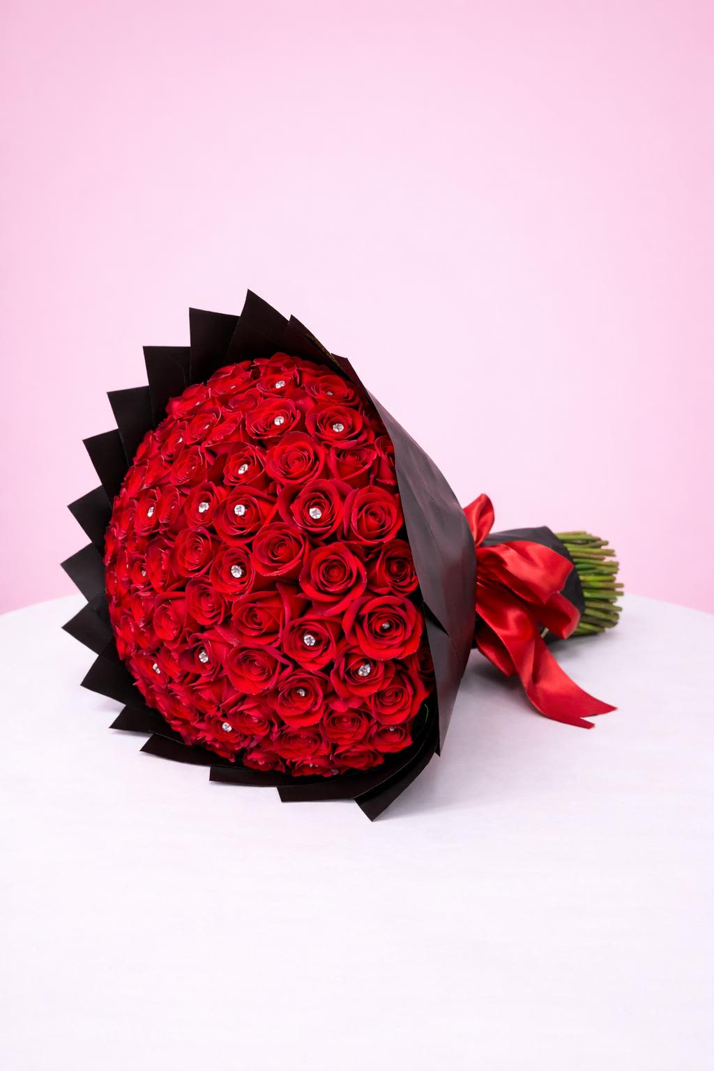 100 Roses Bouquet - 100 Long Stem Red Roses.  Meticulously Wrapped with black paper with a satin red bow.       