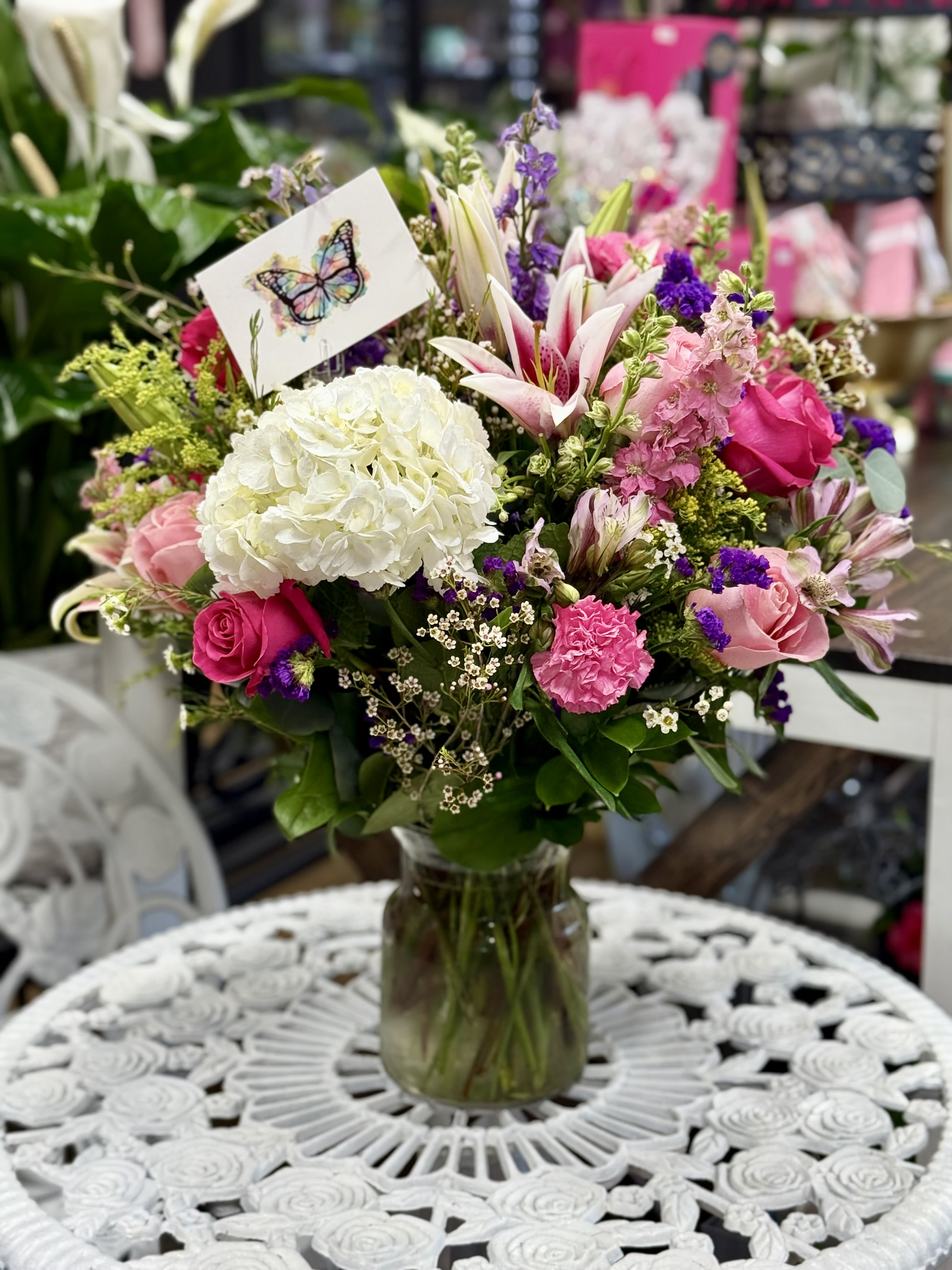 Blush Garden  - “A stunning glass vase filled with a vibrant mix of fresh flowers, including elegant roses, graceful lilies, lush hydrangeas, and a delightful assortment of seasonal blooms. This beautifully arranged bouquet radiates color and charm—making it the perfect gift!"  *Med Size Vase Arrangement. 