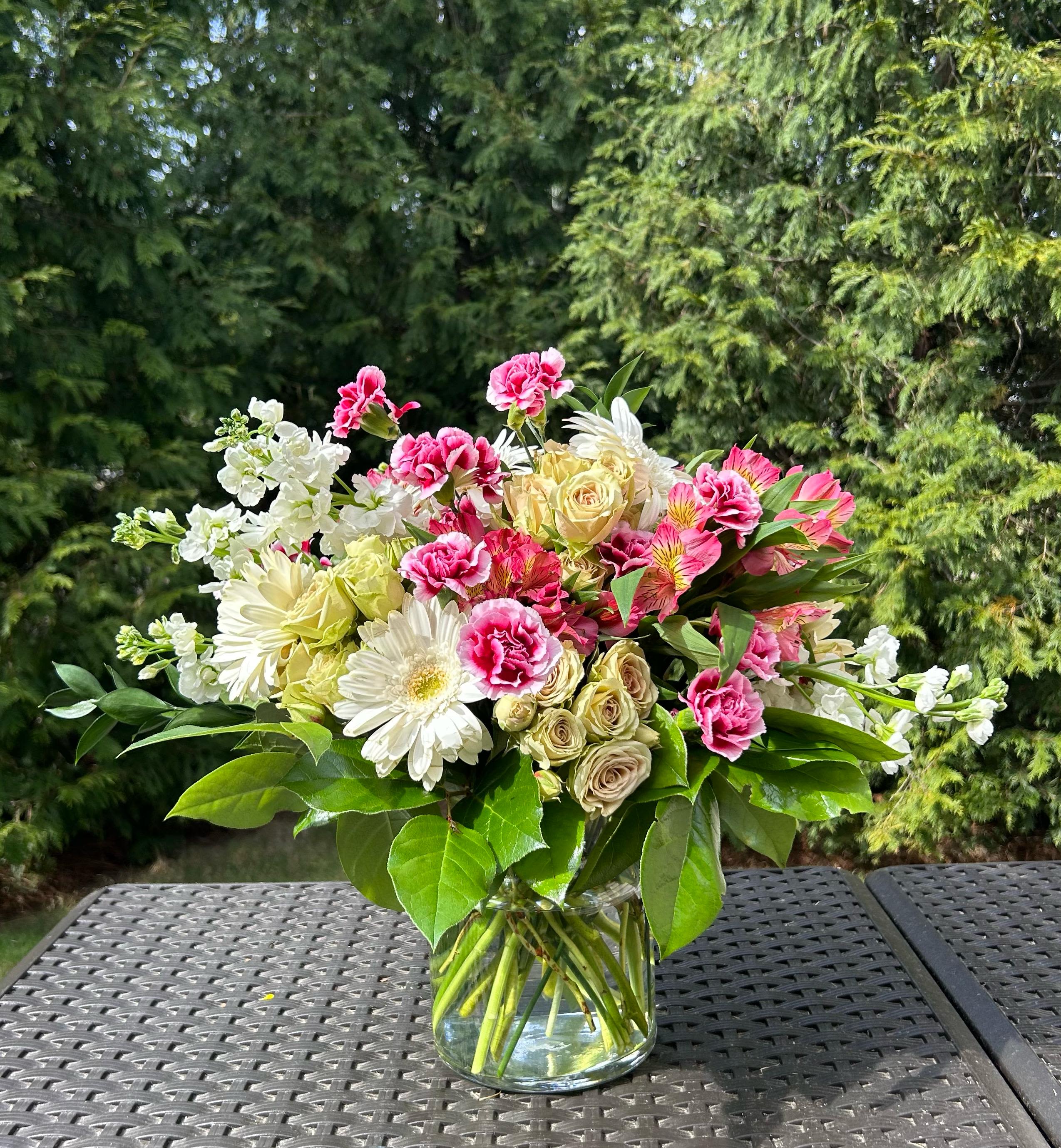 Mia Bouquet - Real flowers, real luxury. Whether it's for a birthday, a thank you, or just because, this fresh floral arrangement is designed to impress and delight.  Bloom Details: Stock, Gerbera Daisies, Spray Roses, Alstroemeria, Green Foliage Mix Crystal Clear Glass Vessel All Occasion  Place your Order Online Monday to Saturday before 1:00 p.m. (E.T.) for same-day delivery. “Orders received after hours will be delivered the next business day”. Check our coverage area. Occasionally, flowers and/or container substitutions happen due to weather, seasonality, and market conditions, which may affect availability. If this is the case with the gift you’ve selected, we will ensure that your arrangement's style, theme, and color scheme are preserved and will only substitute items of equal value or higher value.  CARE INSTRUCTIONS Keep the flower arrangement hydrated with natural water and change the water every two days. Do not spray any cleaning product on the flower arrangement. Do not place heavy objects directly on the flower arrangement. Keep flower arrangements out of direct sunlight and extreme heat.