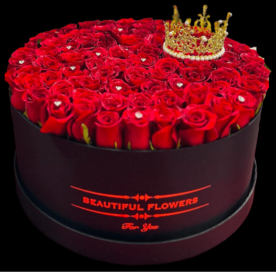 Round box of red roses topped with a gold crown